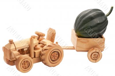 Toy tractor with green pumpkin.