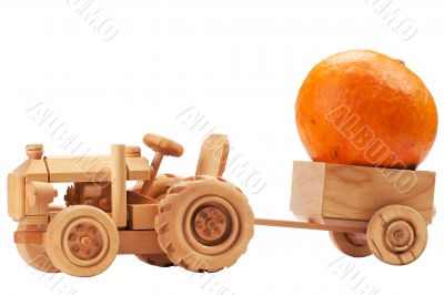 Toy tractor with orange pumpkin.