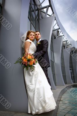 Bride and groom near collonnade