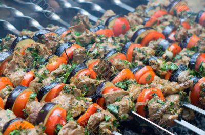 Cooking tasty kebab with vegetables