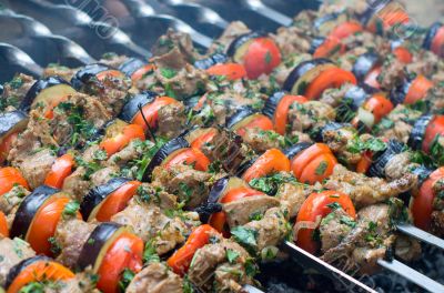 Cooking tasty kebab with vegetables