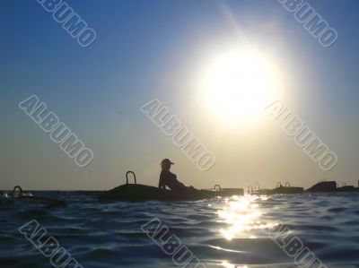 Woman and splashing water of the sea and big sun