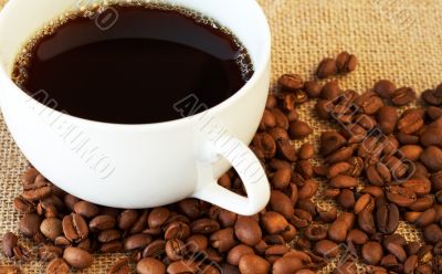 Cup of coffee with coffee beans