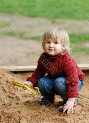 child plays with sand