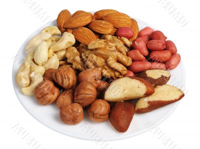 Set of nuts on a white plate, isolated