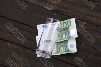 Empty Glass and Two One Hundred Euro Banknotes