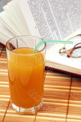 Multifruit juice with book and glasses