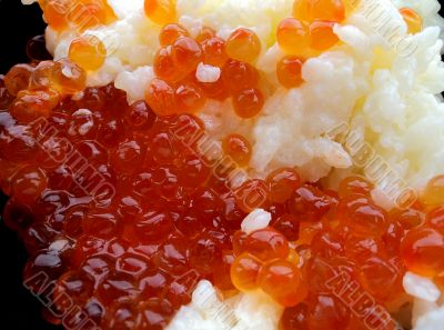 Rice with red caviar in black chalice