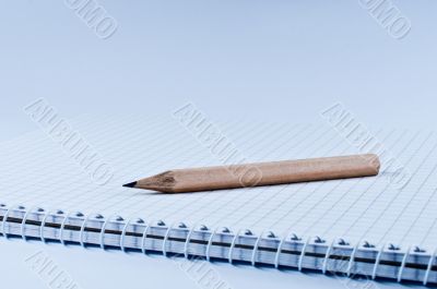 Pencil on open notebook side view