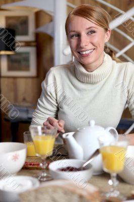 Woman eating breakfast at table
