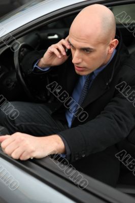 Man on phone getting out of his car