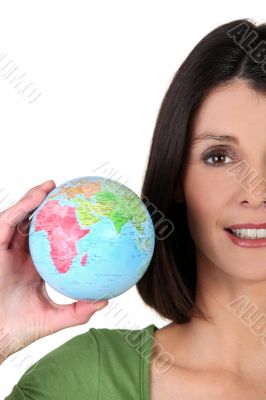 young woman taking a little globe in her hand