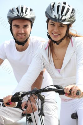 Young couple riding bicycles