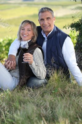 couple drinking wine in the vineyard