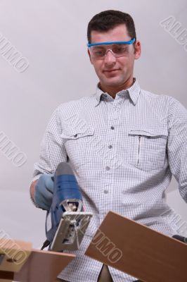 Man cutting a floorboard
