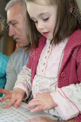 Young girl using a computer keyboard