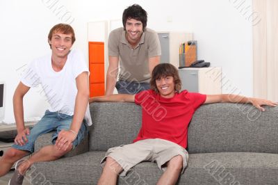 Three lads relaxing at home