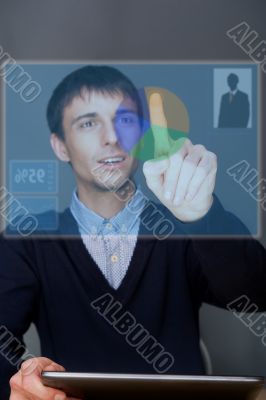 Portrait of adult business man pressing a touchscreen button.