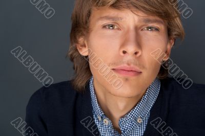 Portrait of young man with smart and wise look. Looking at camera.