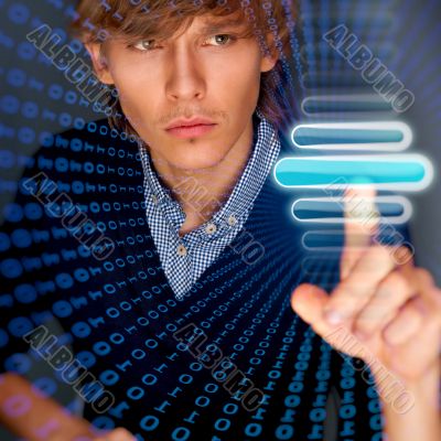 Young business man pressing a touchscreen button while working a