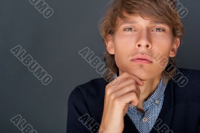 Portrait of young man with smart and wise look. Looking at camer