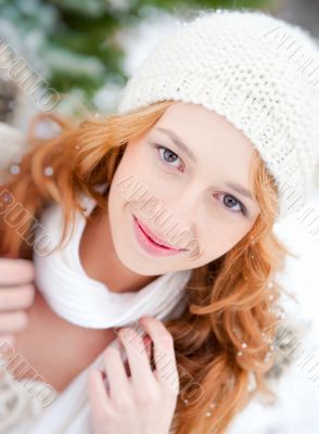 Portrait of beautiful young red hair woman outdoors in winter lo