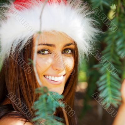 Portrait of a sexy young female smiling in a park and looking at