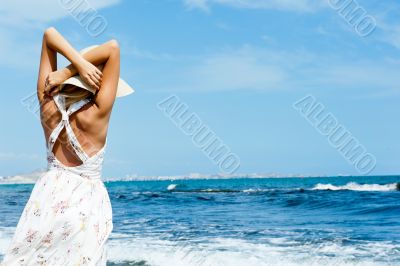 Young fashionable woman wearing hat and sophistical dress on the