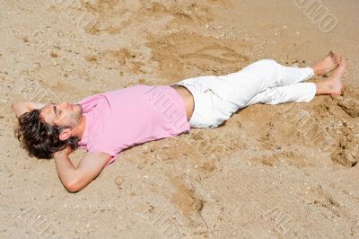 Portrait of attractive and happy man on the beach relaxing and d