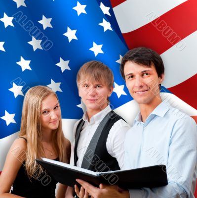 Group of young students standing with their teacher against Amer