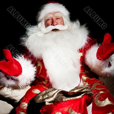 Santa sitting with a sack indoor at dark night room