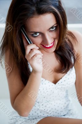 Closeup portrait of a pretty young female sitting at cafe in mor