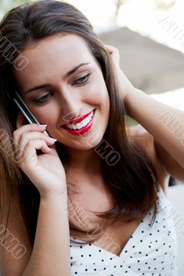 Closeup portrait of a pretty young female sitting at cafe in mor