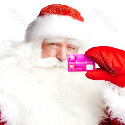 Traditional Santa Claus holding and sowing credit card while giv
