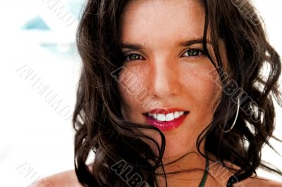 Portrait of a pretty young woman standing at modern resort and l