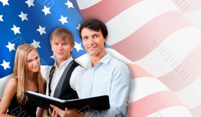 Group of young students standing with their teacher against Amer