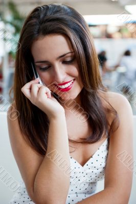 Closeup portrait of a pretty young female sitting at cafe in mor