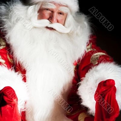 Santa sitting with a sack indoor at dark night room