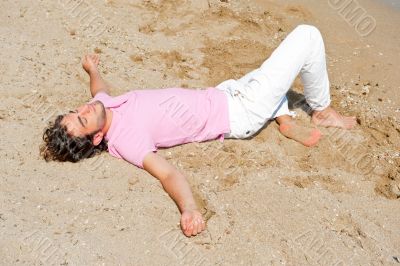 Portrait of attractive and happy man on the beach relaxing and d