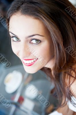 Closeup portrait of a pretty young female having a cup of coffee