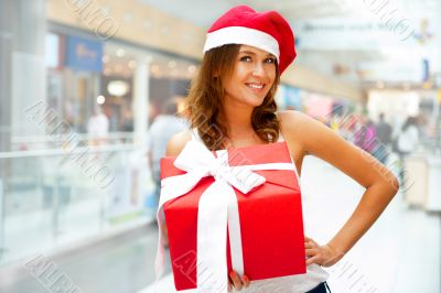 Portrait of young excited pretty woman standing inside shopping 