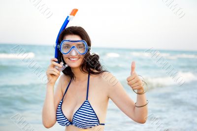 Young hispanic woman with wet skin and with a snorkel standing o