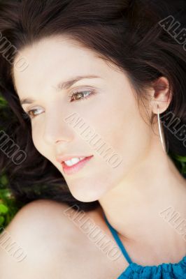 Pretty brunette woman wearing elegant dress relaxing outdoor in 