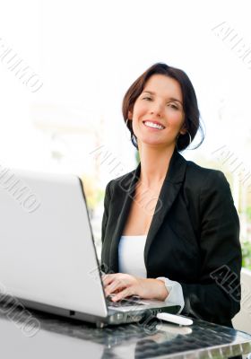 Young business woman on a laptop using wireless internet connect