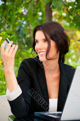 Business woman making payments online using laptop and credit ca