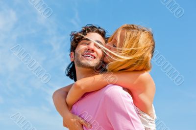 An attractive couple fooling around on the beach