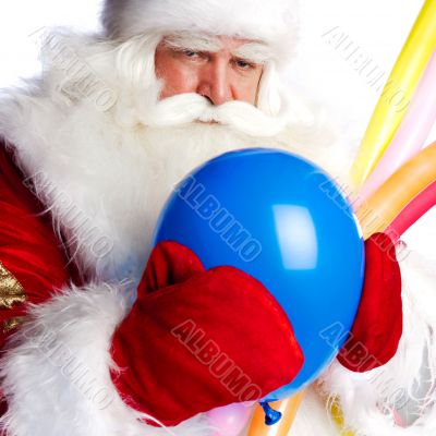 Traditional Santa Claus holding balloons for children. Isolated 