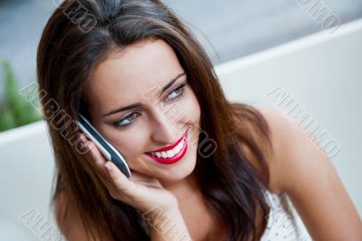Closeup portrait of a pretty young female sitting at cafe in mor