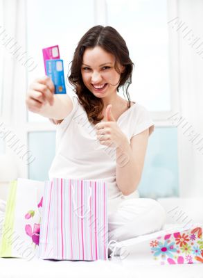 Portrait of young beautiful awake woman with gifts surrounding h