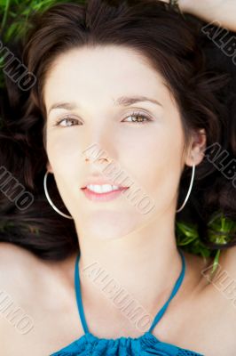 Pretty brunette woman wearing elegant dress relaxing outdoor in 